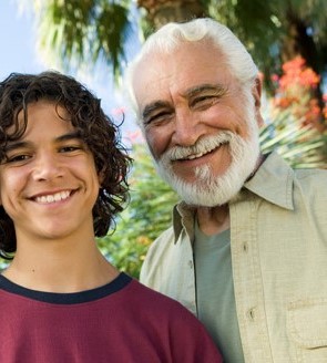 Boy (13-15) with Father and Grandfather outdoors, front view portrait.