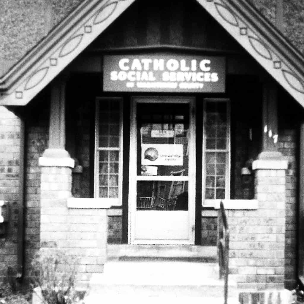 Black and white photo of the front porch of Catholic Social Services of Washtenaw County when it first operated out of a residential house.