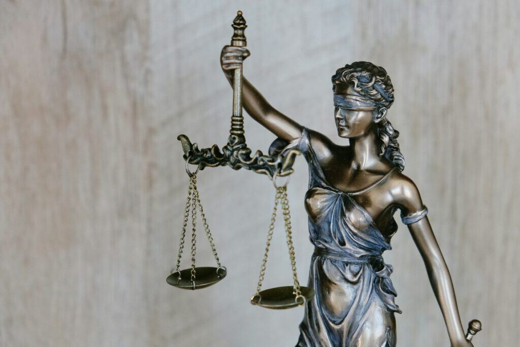 Justice Scale statue representing senior legal support and advocacy.