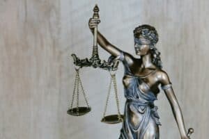 Justice Scale statue representing senior legal support and advocacy.